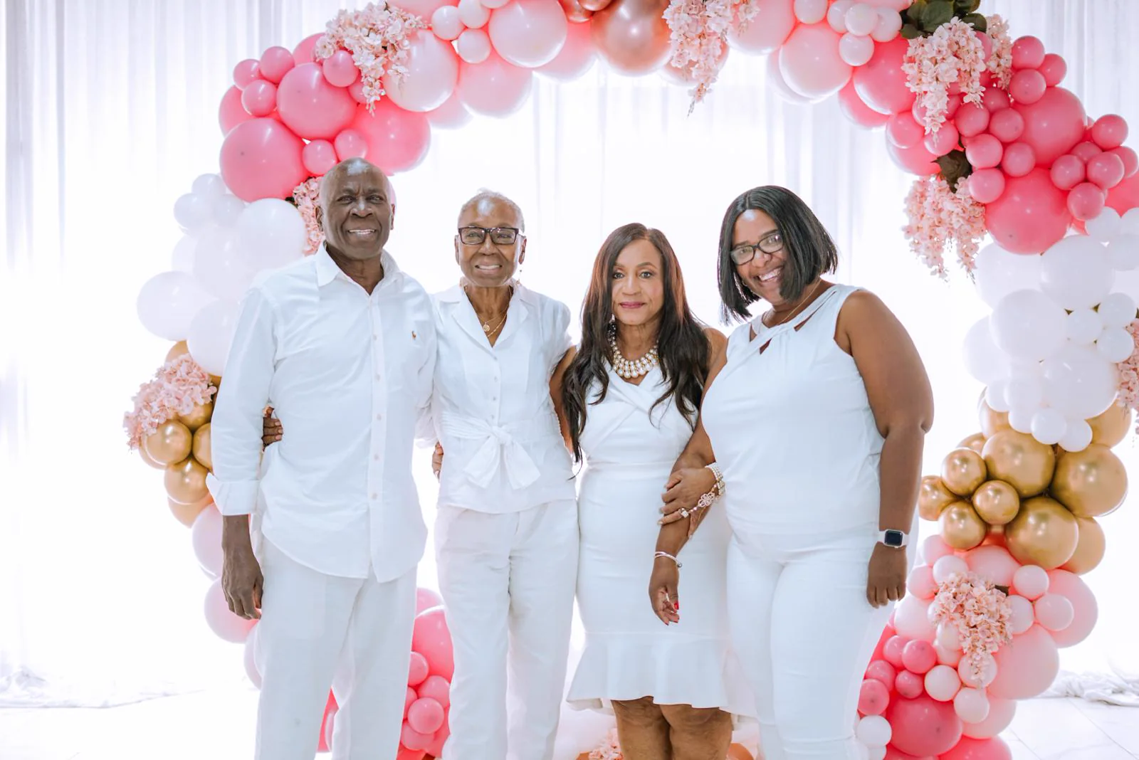 Dr. Patti Mills celebrating a family milestone, surrounded by loved ones dressed in white